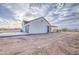 Exterior view showcasing the garage, back door, and covered patio of this beautiful home at 28003 N Faded Creek Dr, Florence, AZ 85132