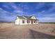 A view of the side of the house showing the covered patio and the wide open space of the lot at 28003 N Faded Creek Dr, Florence, AZ 85132
