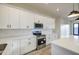 Bright kitchen featuring white cabinets, quartz countertops, stainless steel appliances, and subway tile backsplash at 28003 N Faded Creek Dr, Florence, AZ 85132