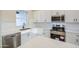 Well-lit kitchen with stainless steel appliances, white cabinets, subway tile backsplash, and quartz countertops at 28003 N Faded Creek Dr, Florence, AZ 85132