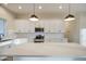 Modern kitchen with white cabinets, stainless steel appliances, quartz countertop, and pendant lighting at 28003 N Faded Creek Dr, Florence, AZ 85132