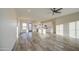 Open floor plan with wood-look tile, white walls, stainless appliances, and lots of bright light at 28003 N Faded Creek Dr, Florence, AZ 85132