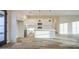 Bright open-concept living area with kitchen, dining, and living spaces featuring wood-look tile floors at 28003 N Faded Creek Dr, Florence, AZ 85132