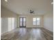 Open-concept living room boasts wood-look tile flooring, neutral walls, and contemporary ceiling fan at 28003 N Faded Creek Dr, Florence, AZ 85132