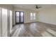 Neutral living room features wood-look tile, bright windows, and a ceiling fan at 28003 N Faded Creek Dr, Florence, AZ 85132
