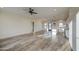 Large living room featuring tile flooring, ceiling fan, and kitchen area with stainless steel appliances at 28003 N Faded Creek Dr, Florence, AZ 85132