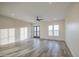 Bright living room featuring wood-look tile flooring, neutral walls, ceiling fan and windows providing lots of natural light at 28003 N Faded Creek Dr, Florence, AZ 85132