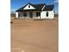 Charming single-story home featuring a white exterior, a dark roof, and a covered porch with wooden columns at 28003 N Faded Creek Dr, Florence, AZ 85132