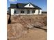A single-story home featuring a white exterior, a dark roof, and a covered porch with wooden columns at 28003 N Faded Creek Dr, Florence, AZ 85132