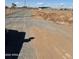 View of the property featuring the surrounding area with gravel road and new homes in the distance at 28003 N Faded Creek Dr, Florence, AZ 85132