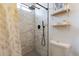 Modern bathroom featuring a tiled shower with bronze fixtures and floating shelves at 3015 E Dahlia Dr, Phoenix, AZ 85032