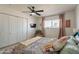 Bedroom featuring patterned bedspread, tv, closet and curtains at 3015 E Dahlia Dr, Phoenix, AZ 85032