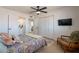 Bedroom features a decorative bed, tv, chair, and view of the bathroom at 3015 E Dahlia Dr, Phoenix, AZ 85032