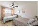 Comfortable bedroom featuring two beds, a ceiling fan and lots of natural light at 3015 E Dahlia Dr, Phoenix, AZ 85032