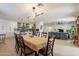 Open-concept dining area adjacent to a modern kitchen, featuring a large table and chairs at 3015 E Dahlia Dr, Phoenix, AZ 85032
