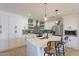 Bright and modern kitchen with white cabinets, stainless steel appliances, and bar seating at 3015 E Dahlia Dr, Phoenix, AZ 85032