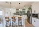Bright kitchen with island seating, stainless appliances, and stylish backsplash at 3015 E Dahlia Dr, Phoenix, AZ 85032
