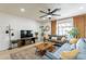 Cozy living room with large sofa, television, and ceiling fan at 3015 E Dahlia Dr, Phoenix, AZ 85032