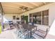 Charming covered patio featuring a dining set, ceiling fan, and comfortable seating for outdoor enjoyment at 3015 E Dahlia Dr, Phoenix, AZ 85032