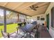 Spacious covered patio with an inviting dining area, ceiling fan, and a view of the beautifully landscaped yard at 3015 E Dahlia Dr, Phoenix, AZ 85032