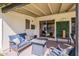 Relaxing covered patio with cozy seating, a small table, and a view into the home's interior through a sliding door at 3015 E Dahlia Dr, Phoenix, AZ 85032