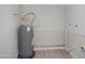 Bright utility room with water heater, access panel, and modern wood-style flooring at 3249 E Sunnyside Ln, Phoenix, AZ 85032
