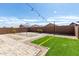 Landscaped backyard featuring artificial turf, stone pathways, and string lights at 40049 W Hopper Dr, Maricopa, AZ 85138
