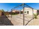 Backyard with gravel and stone landscaping and metal gazebo-style structure at 40049 W Hopper Dr, Maricopa, AZ 85138