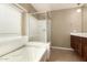 Bathroom with enclosed glass shower and garden tub at 40049 W Hopper Dr, Maricopa, AZ 85138