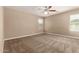 Expansive primary bedroom with plush carpeting, lots of natural light, and ample closet space at 40049 W Hopper Dr, Maricopa, AZ 85138