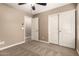 Bedroom with neutral carpet and paint, ceiling fan, and access to a closet at 40049 W Hopper Dr, Maricopa, AZ 85138