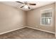 Bedroom with neutral carpet and paint, ceiling fan, and one window at 40049 W Hopper Dr, Maricopa, AZ 85138