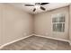 Neutral bedroom has standard window, ceiling fan, and carpet flooring at 40049 W Hopper Dr, Maricopa, AZ 85138