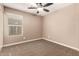 Bedroom with neutral carpet and paint, fan, and one window at 40049 W Hopper Dr, Maricopa, AZ 85138