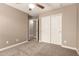 Bedroom features closet, ceiling fan, neutral paint, and carpet flooring at 40049 W Hopper Dr, Maricopa, AZ 85138