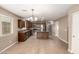 Bright kitchen with ample tile flooring, wood cabinets, granite counters, stainless appliances and a functional island at 40049 W Hopper Dr, Maricopa, AZ 85138