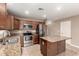 This home features a modern kitchen, stainless steel appliances and a granite-topped kitchen island at 40049 W Hopper Dr, Maricopa, AZ 85138