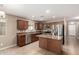 Well-equipped kitchen with stainless steel appliances, granite countertops and center island for added convenience at 40049 W Hopper Dr, Maricopa, AZ 85138