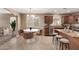 Cozy kitchen nook with table, seating, stainless steel appliances, and a granite-topped center island at 40049 W Hopper Dr, Maricopa, AZ 85138