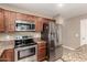 A modern kitchen boasts stainless steel appliances, granite countertops, and a large island for cooking at 40049 W Hopper Dr, Maricopa, AZ 85138