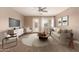 Cozy living room with a neutral color palette, comfortable seating, and a ceiling fan at 40049 W Hopper Dr, Maricopa, AZ 85138