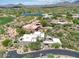 Beautiful aerial view of a contemporary house with green landscaping, nearby golf course and lakes at 40478 N 108Th Pl, Scottsdale, AZ 85262