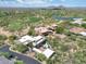 Beautiful aerial view of the house surrounded by greenery, nearby golf course, and lakes at 40478 N 108Th Pl, Scottsdale, AZ 85262