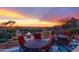 Cozy back patio setting with outdoor furniture and scenic sunset views at 40478 N 108Th Pl, Scottsdale, AZ 85262