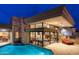 Beautiful backyard with a sparkling pool, integrated lighting, and modern design elements at dusk at 40478 N 108Th Pl, Scottsdale, AZ 85262