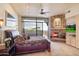 Spacious bedroom featuring a stone fireplace, access to an outdoor patio with a jacuzzi, and neutral carpet at 40478 N 108Th Pl, Scottsdale, AZ 85262