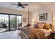 Comfortable bedroom featuring a four-poster bed, an outdoor seating area, and natural light at 40478 N 108Th Pl, Scottsdale, AZ 85262