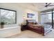 Comfortable bedroom featuring a large window with outdoor views and a stylish ceiling fan at 40478 N 108Th Pl, Scottsdale, AZ 85262
