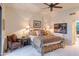 Elegant bedroom with a four-poster bed, a sitting area, and ample natural light at 40478 N 108Th Pl, Scottsdale, AZ 85262