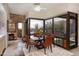 Dining room with glass top table, stone accent wall, and outdoor desert views at 40478 N 108Th Pl, Scottsdale, AZ 85262